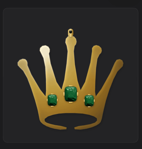 A gold crown pendant set with three emeralds
